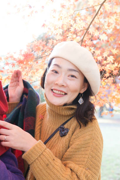 istock Young family enjoying autumn under Japanese maple tree 889451472