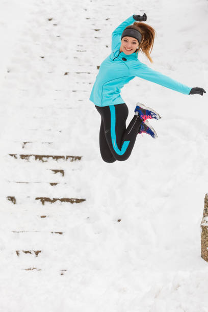 istock Young girl jumping on the snow. 889454434