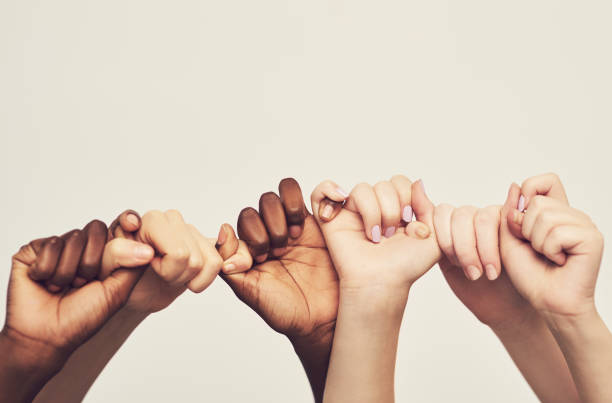 sticking together - hand raised arms raised multi ethnic group human hand imagens e fotografias de stock