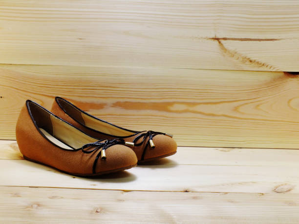 istock lady flat shoes on wooden background and space copy 889454808