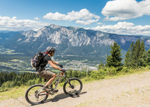istock Lonely mountainbiker is riding uphill at tri-border area, Carinthia. 889454886