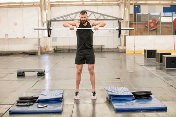 istock Lifting barbell in gym 889457338