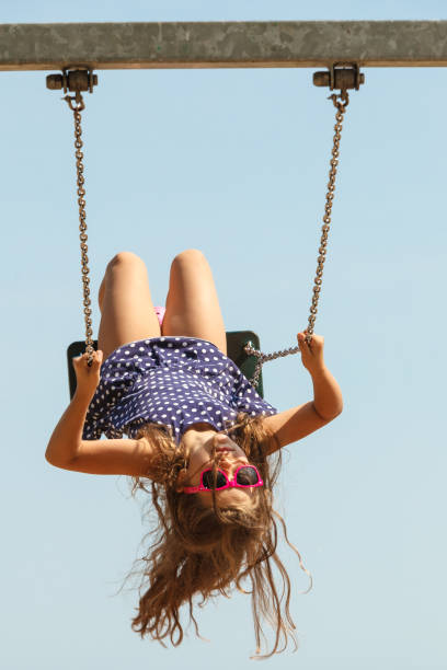 istock Playful crazy girl on swing. 889457686
