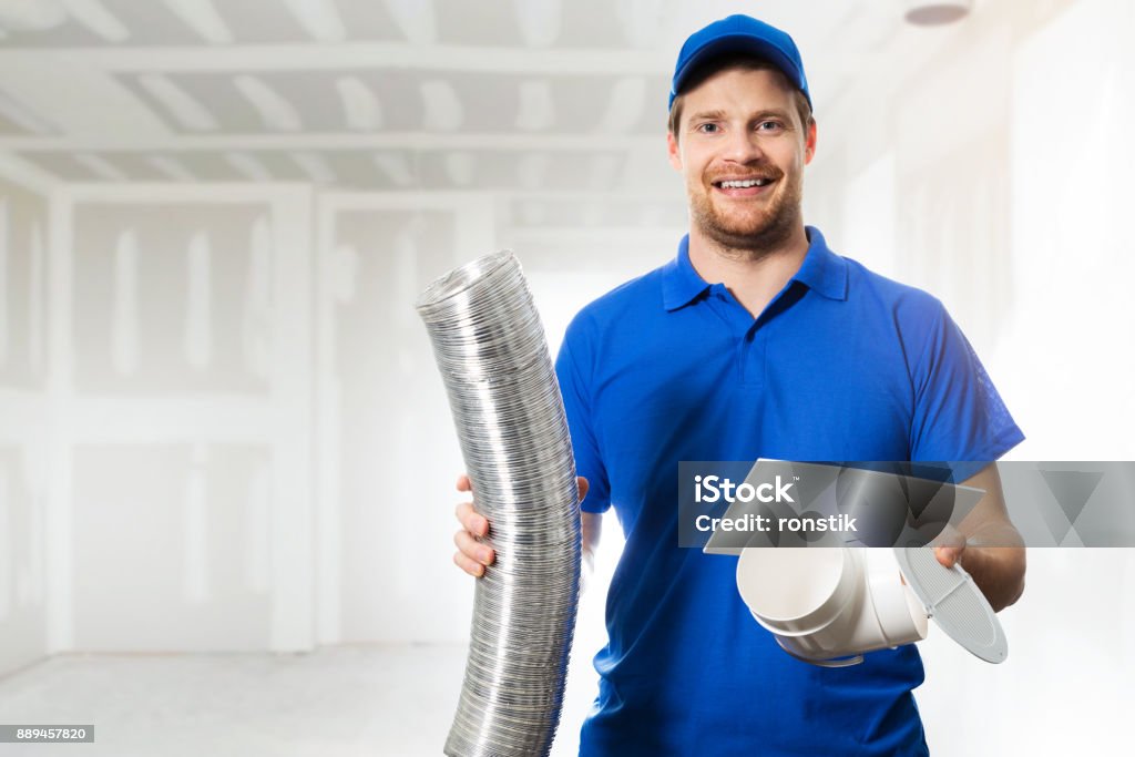 hvac technician ready to install ventilation system in house Air Duct Stock Photo