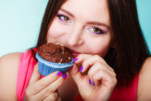 istock Smiling woman holds chocolate cake in hand 889457924