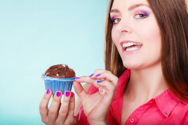 istock Smiling woman holds chocolate cake in hand 889460522