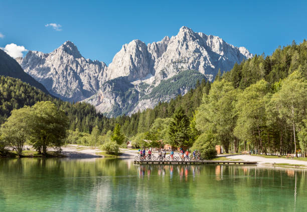 Group of mountainbikers at Jasna Lake, Slovenia. A group of mountainbikers is posing on the edge of scenic Lake Jasna in front of the mountain range of the Julian Alps nearby the village of Kranjska Gora. It consists of two interconnected artificial lakes at the confluence of the Velika Pišnica and Mala Pišnica streams. The area around the lake offers nice trails, but you can also enjoy fishing since it is a well-known fishing district.
julian alps stock pictures, royalty-free photos & images