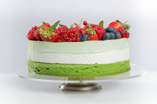 Layer cake with green tea cake and berries Layer cake with green tea cake and berries fruit garnish stock pictures, royalty-free photos & images