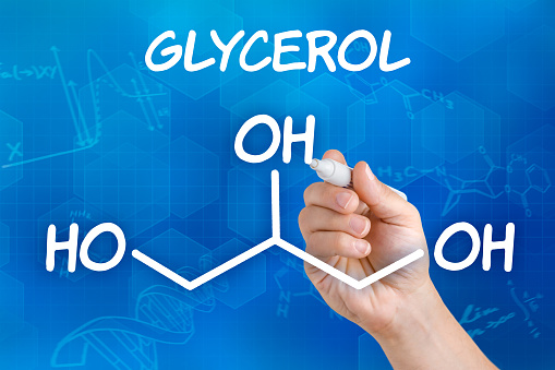 Hand with pen drawing the chemical formula of Glycerol