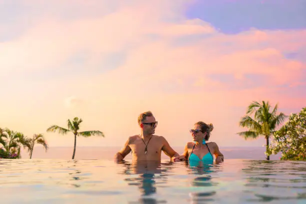 Photo of Couple relaxing in infinity pool