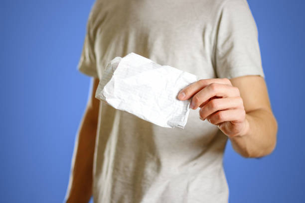 istock The guy shows crumpled clean notebook sheet in a cage 889476570