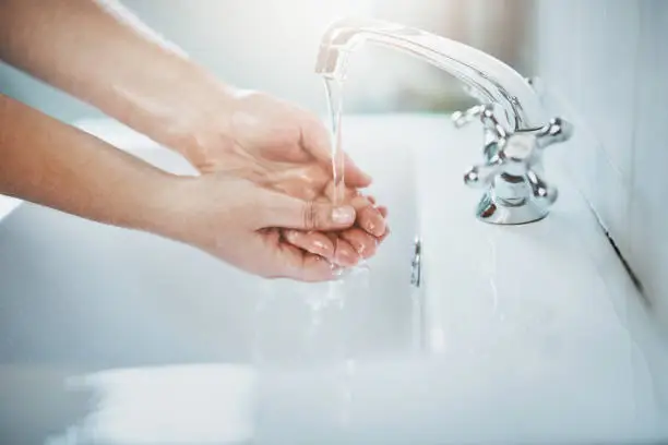 Cropped shot of hands being washed at a tap