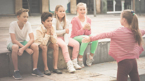 istock boys and girls are communicating outdoor 889512962
