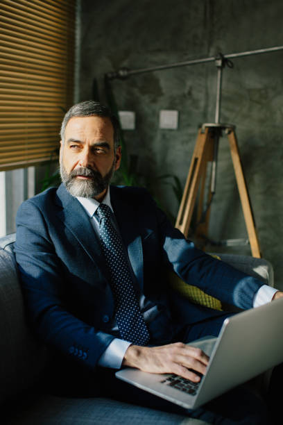 istock Businessman with lap top in his home 889513652
