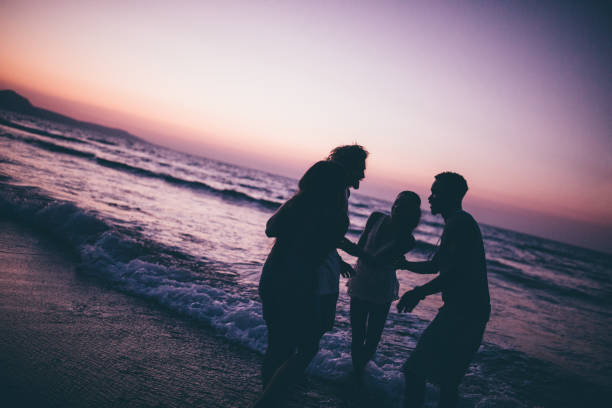 istock Young multi-ethnic hipster friends having fun at the beach 889516326