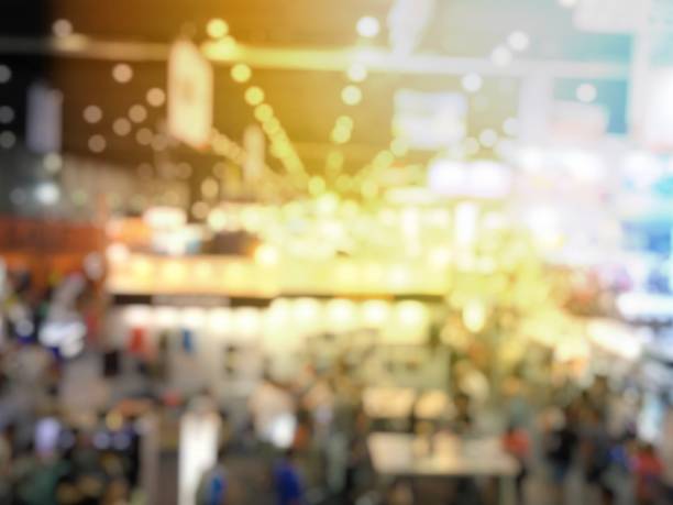 istock blurred image of people in event background with electronic technology photo fair bokeh light vintage tone - business concept 889516852