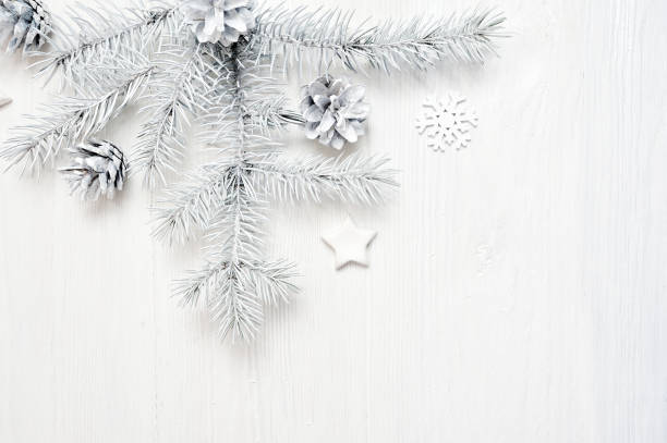 istock Mockup Christmas frame white tree branches border over white wooden background, with space for your text 889521366