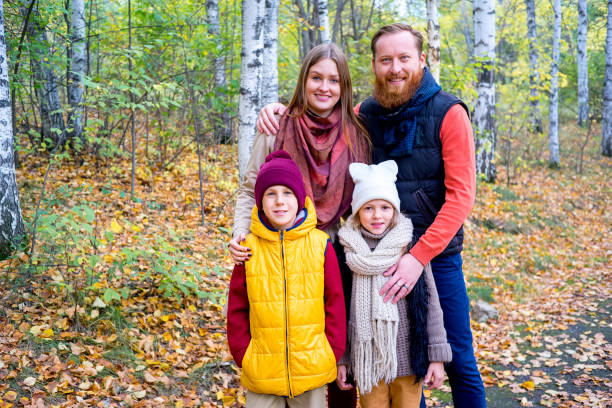 istock Family in an autumn park 889524736
