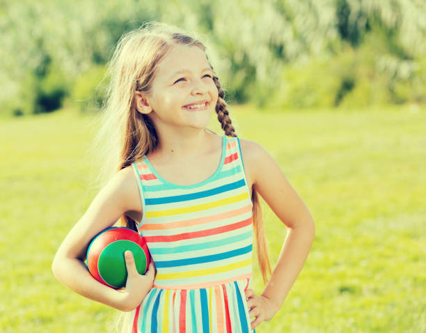 istock smiling girl with ball 889525438