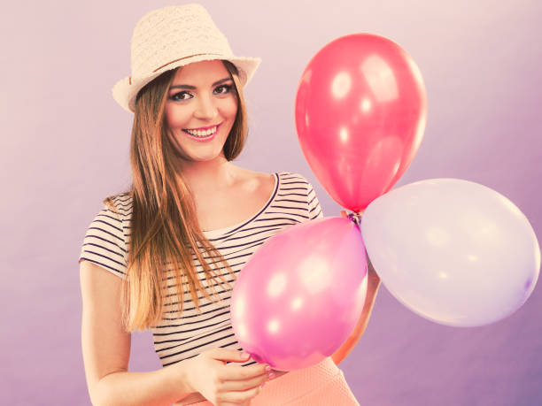 istock Cheering girl with balloons. 889530754
