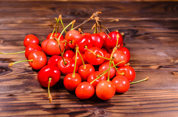 istock Fresh ripe cherries on wooden table 889531000