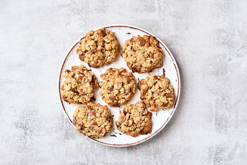 Oats cookies on plate over gray stone background. Top view, flat lay