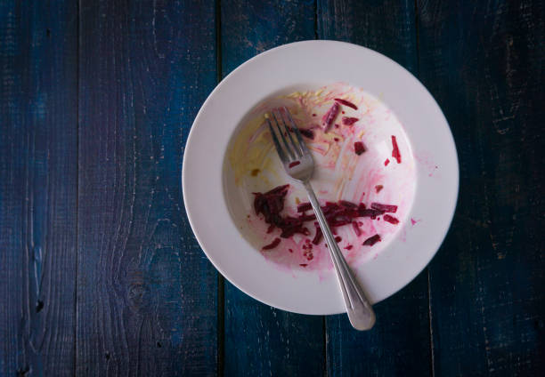 dirty dish with spoon and food remnants