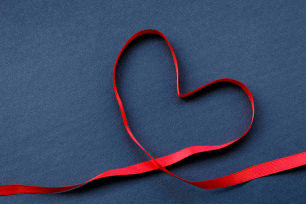 istock Red ribbon in heart shape 889534174