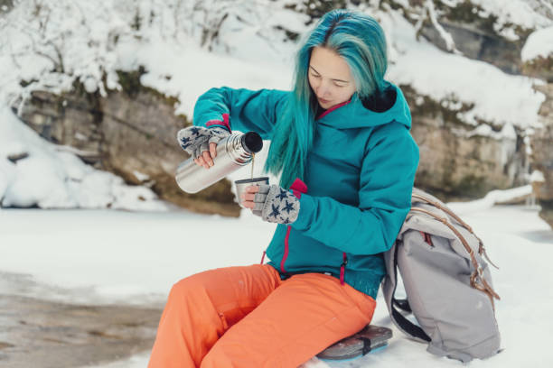 istock Traveler pouring tea to cup in winter. 889536638