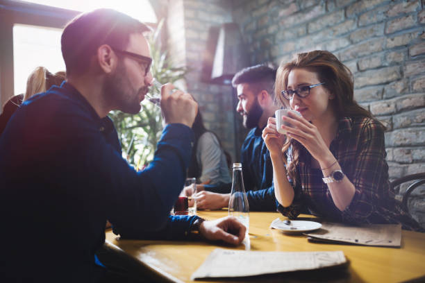 istock Colleagues from work socializing in restaurant and eating togeth 889541210
