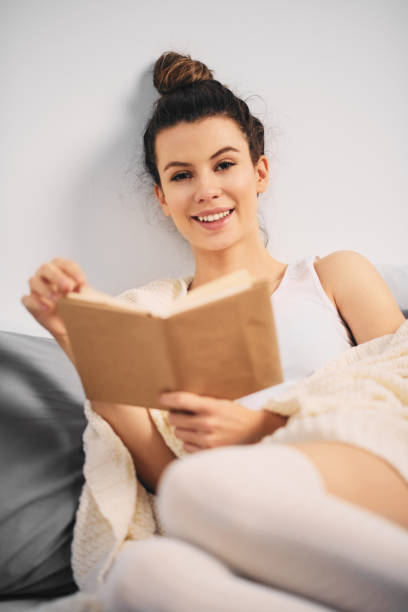 istock Girl sitting on bed 889548494
