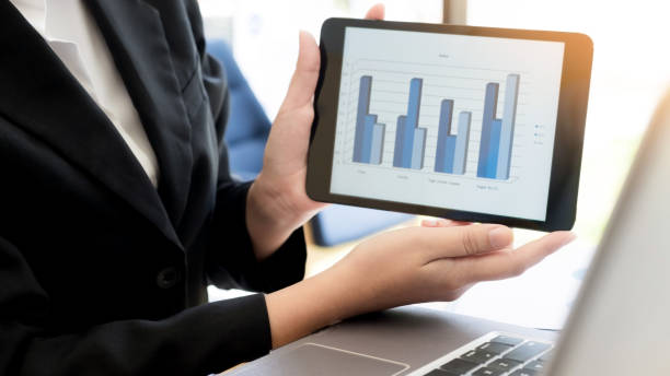 istock Businesswoman Showing Graph On Digital Tablet At Office 889548972