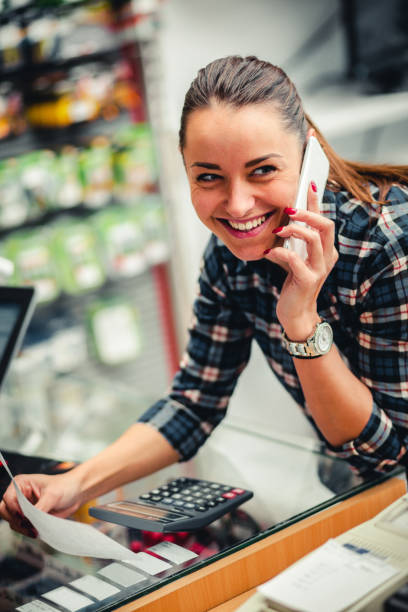 istock woman using on smart phone in store. 889549390