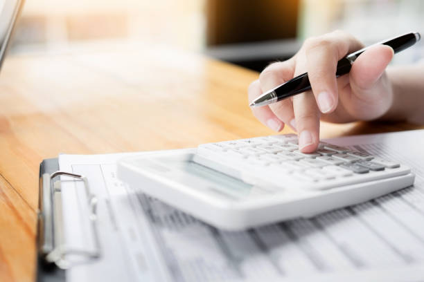 istock Businesswoman Using Calculator At Desk In Office 889554528