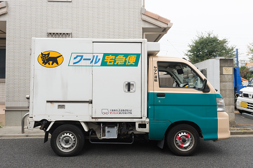 October 13, 2017: Yamato Transport Bicycle Deliver Letter Door to Door In Evening Time in Tokyo Japan on  October 13, 2017