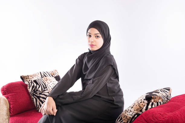 istock Arab beautiful woman sitting on sofa at home 889555464