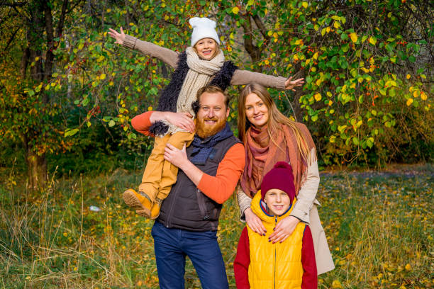 istock Family in an autumn park 889555468