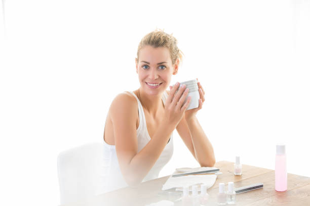 istock woman taking care her nails and drinking tea 889563872