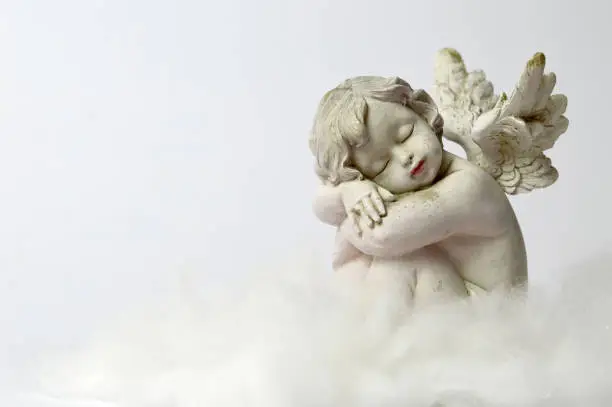 Photo of Angel sleeping on the cloud