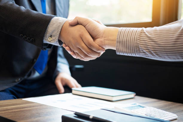 istock Businessmen Shaking Hands In Meeting At Office 889564112