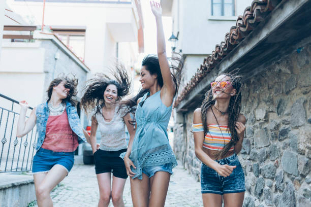 istock Friends holding hands and having fun on old town streets 889573876