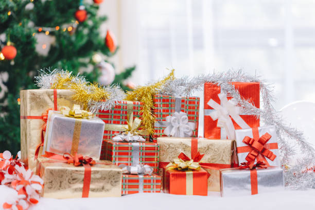 istock Christmas gift box and Christmas decoration with Christmas tree at back side. Copy space for your text. 889581910