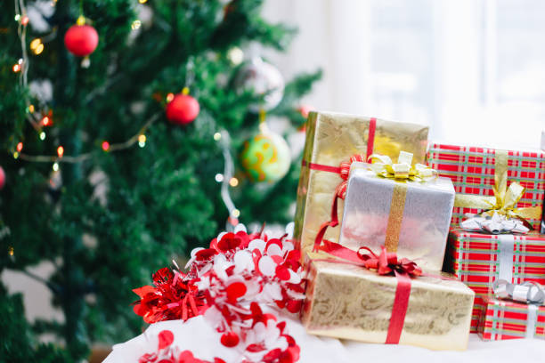 istock Christmas gift box and Christmas decoration with Christmas tree at back side. Copy space for your text. 889582038