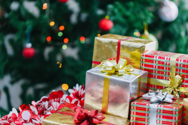 istock Christmas gift box and Christmas decoration with Christmas tree at back side. Copy space for your text. 889582058