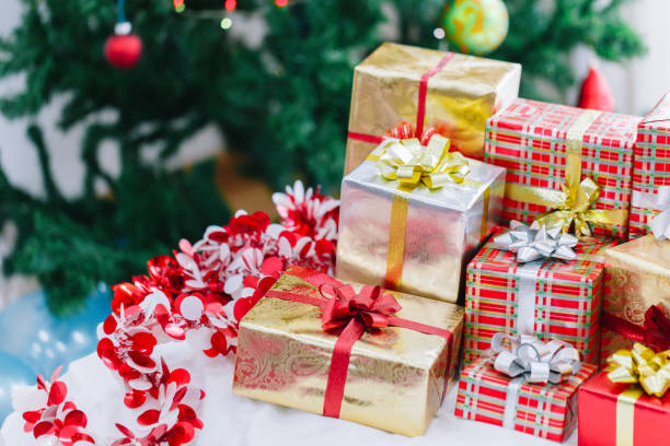 istock Christmas gift box and Christmas decoration with Christmas tree at back side. Copy space for your text. 889582086