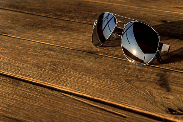 istock the sunglasses silver color is on the wood table 889582088