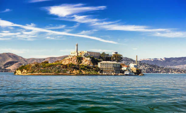 Alcatraz Island in San Francisco Alcatraz Island and former federal penitentiary on sunny day in San Francisco Bay, California alcatraz island photos stock pictures, royalty-free photos & images
