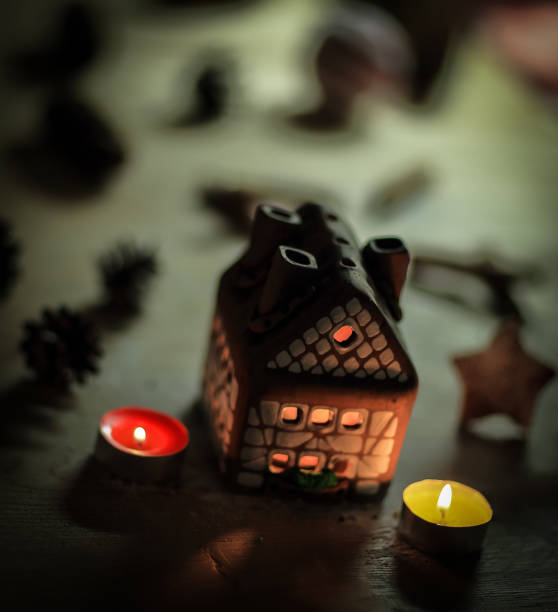 istock gingerbread house candle on blurred background of the table 889586738