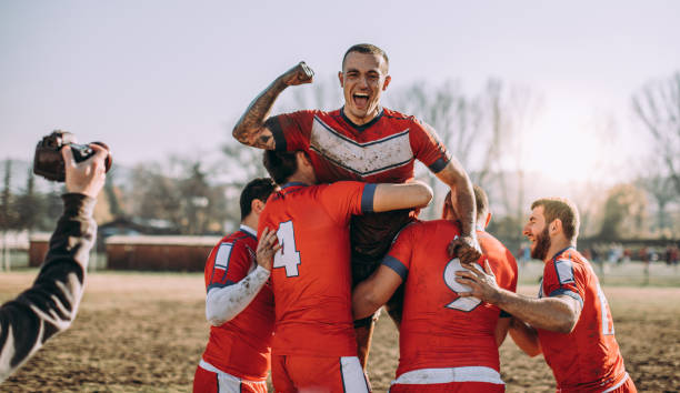 Celebrating victory Young and strong rugby team on the field,celebrating victory. rugby players stock pictures, royalty-free photos & images