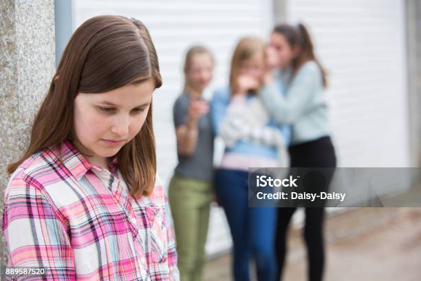 Sad Pre Teen Girl Feeling Left Out By Friends Stock Photo - Download Image Now - Bullying, Loneliness, Pre-Adolescent Child